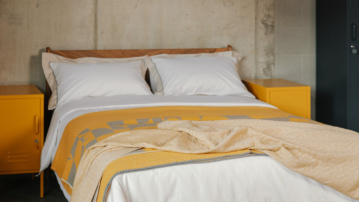 luxury cotton bedding in white and stone with mustard throws 1
