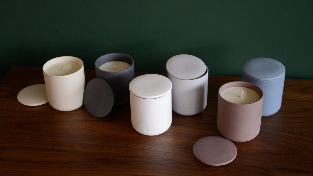 luxury gift-boxed scented candles in matt clay pots with lids in a range of scents and colours