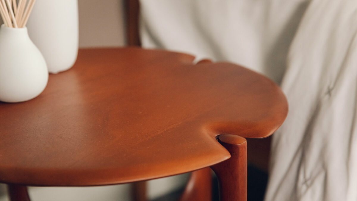 rich red toned mahogany Pi table by Ethnicraft a close up of the top