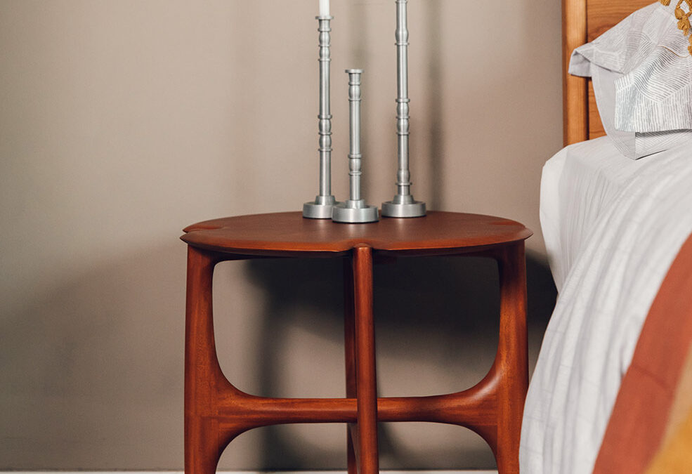 rich toned mahogany side table shown used as a bedside table