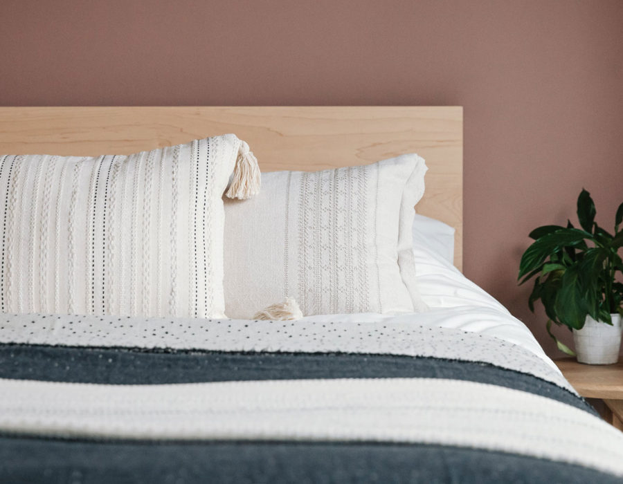 malax embroidered cushion on maple Malabar bed