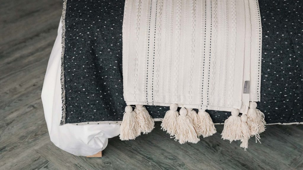 embroidered ivory throw with tassels