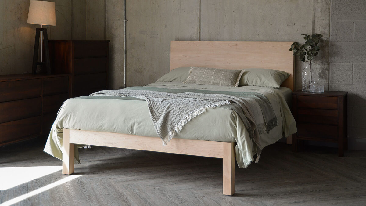 maple Bamford bed with green bedding throws