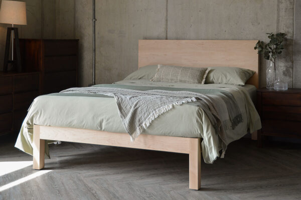 maple Bamford bed with green bedding throws