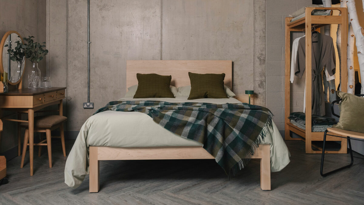 maple Bamford bed with green stonewash bedding and check throw