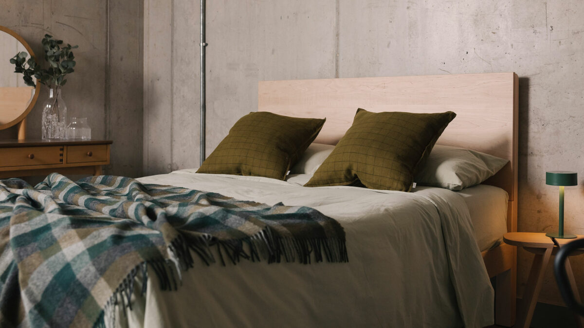 maple bamford with green bedding and bedside lamp