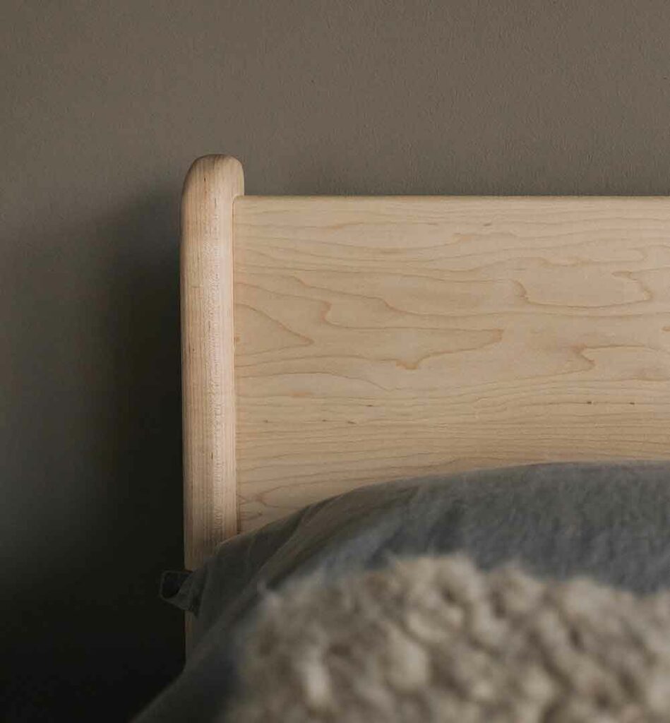 a close view of the Camden headboard in maple wood