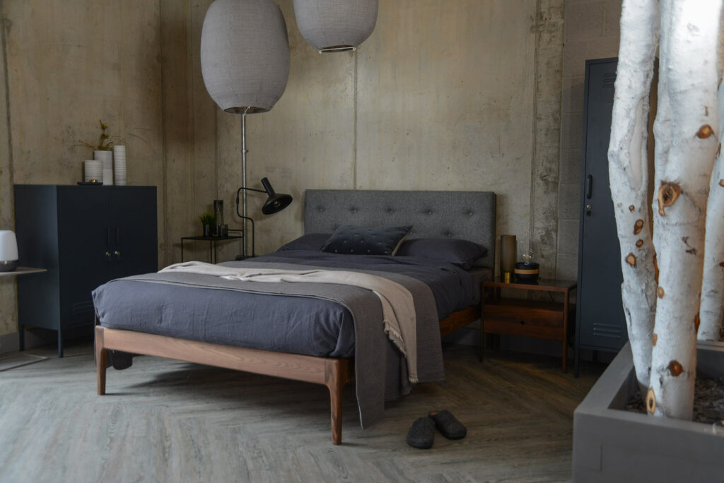 Industrial look bedroom with grey locker storage and grey bedding.