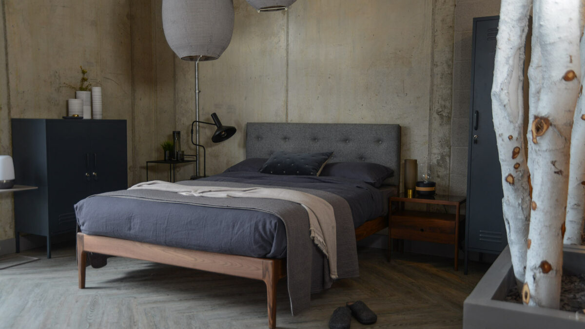 Industrial look bedroom with grey locker storage and grey bedding.