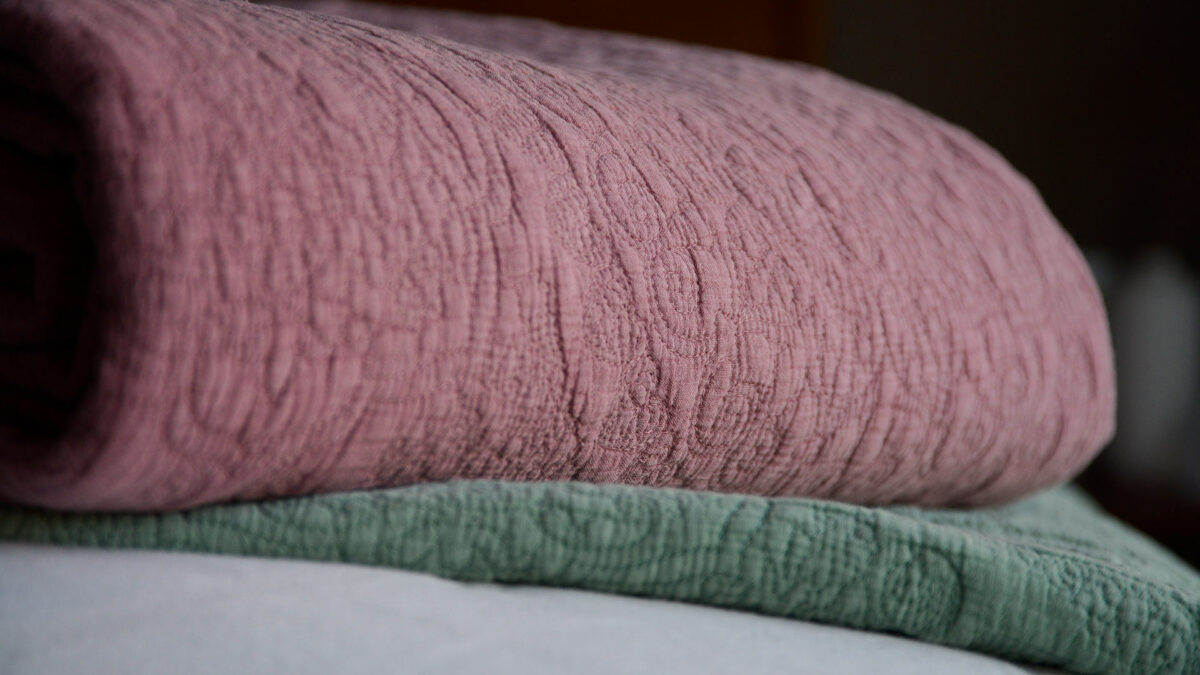 stonewash effect stitched and quilted bedspreads in mauve pink and sage green