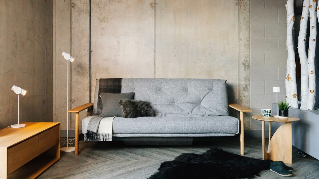 sofa bed with oak arms shown as a sofa and in a room set