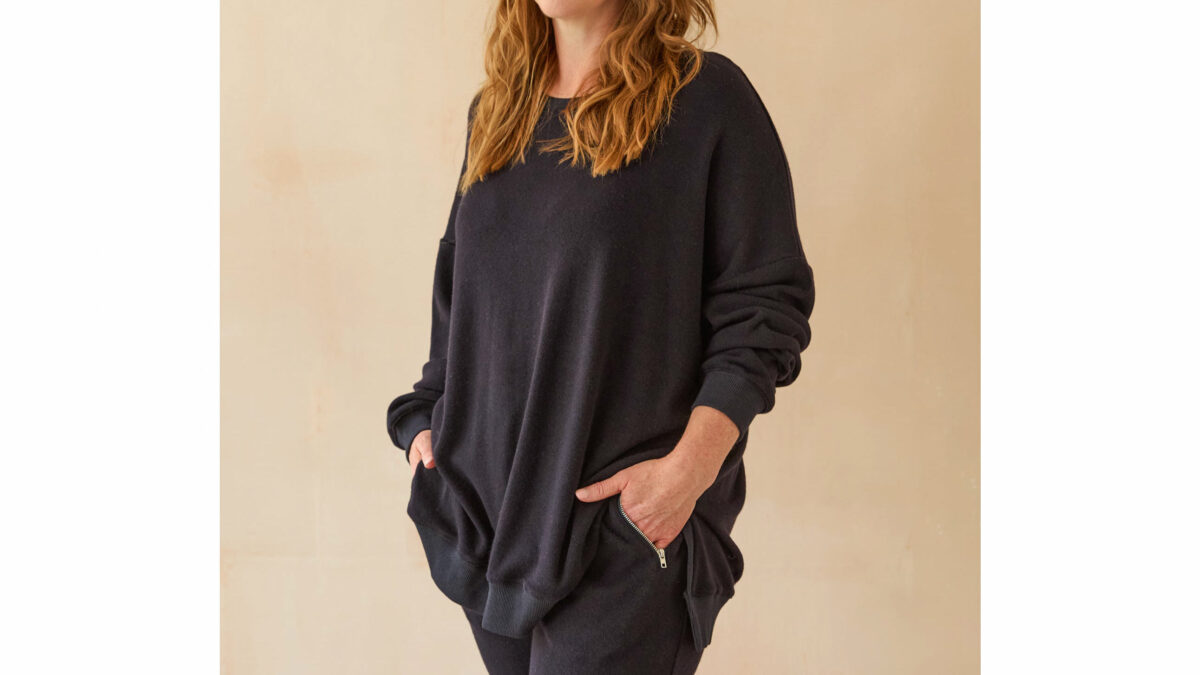 Model wearing long midnight blue sweatshirt.