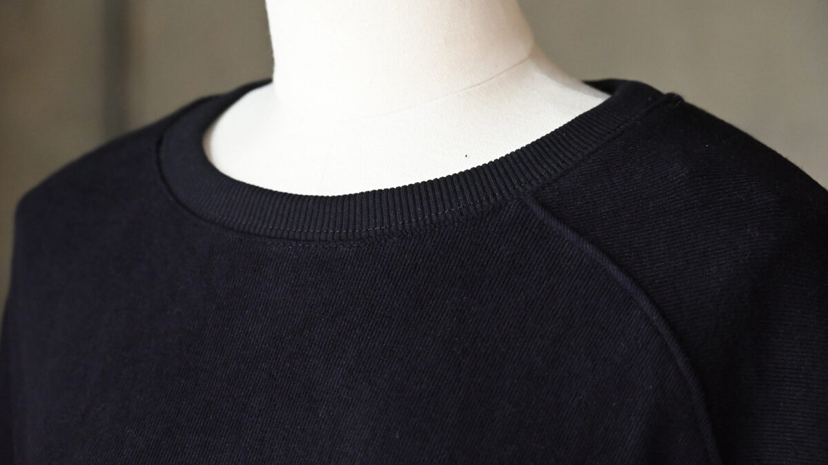 close up of neckline of midnight blue sweatshirt.