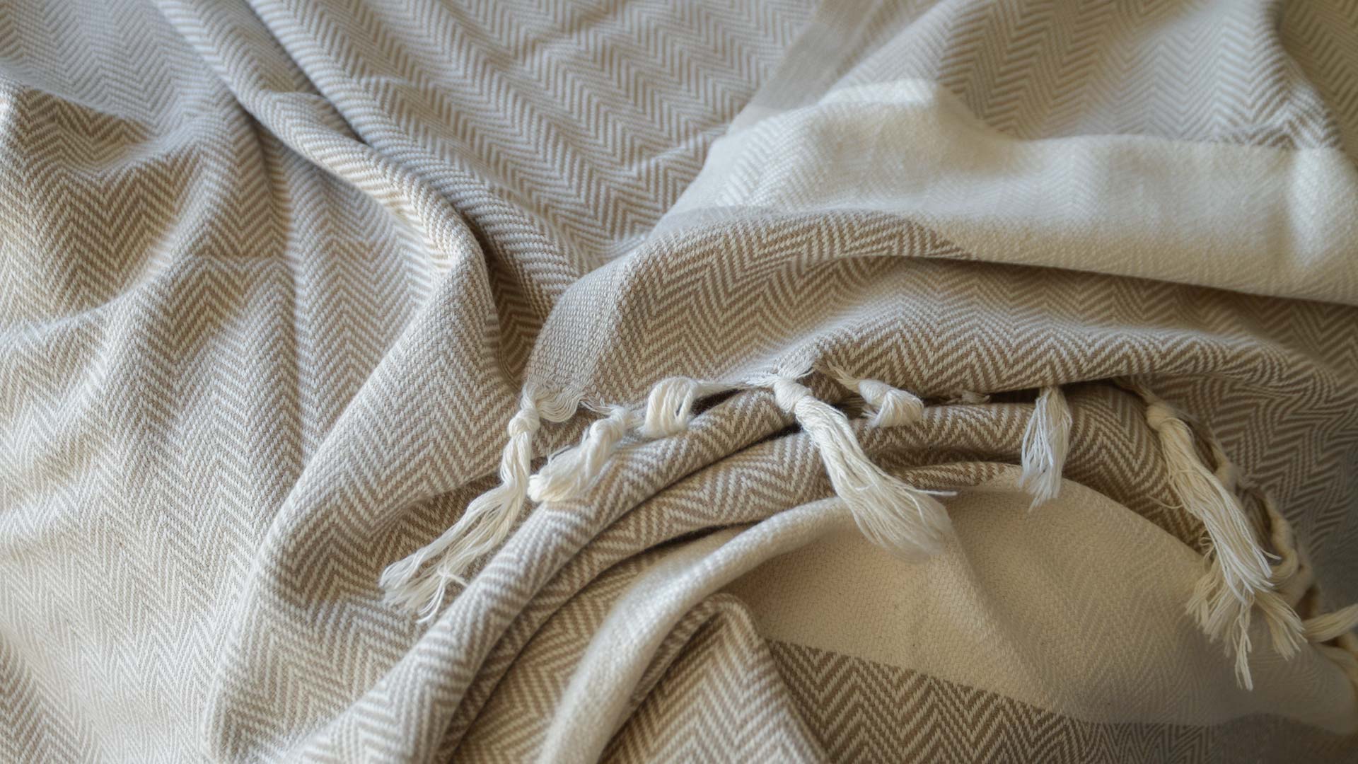 OEKO TEX certified woven cotton blanket with herringbone weave in beige and cream