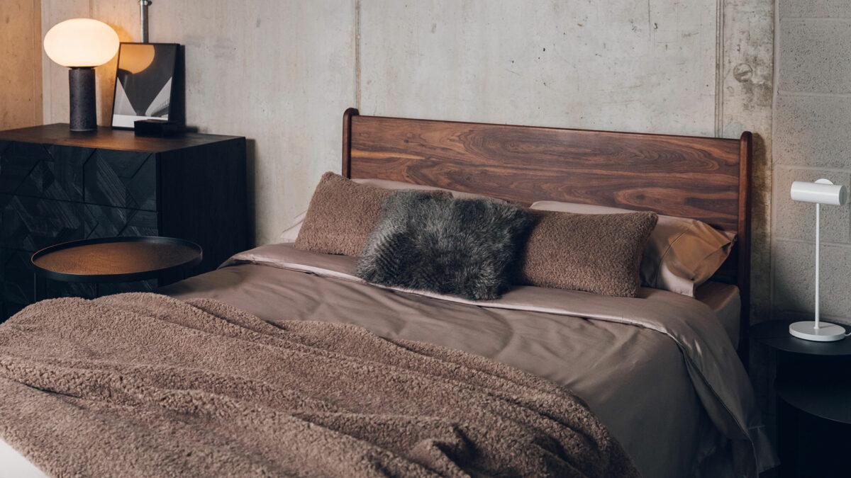 mink colour sateen bedding with faux fur throws shown on an oiled walnut Camden bed