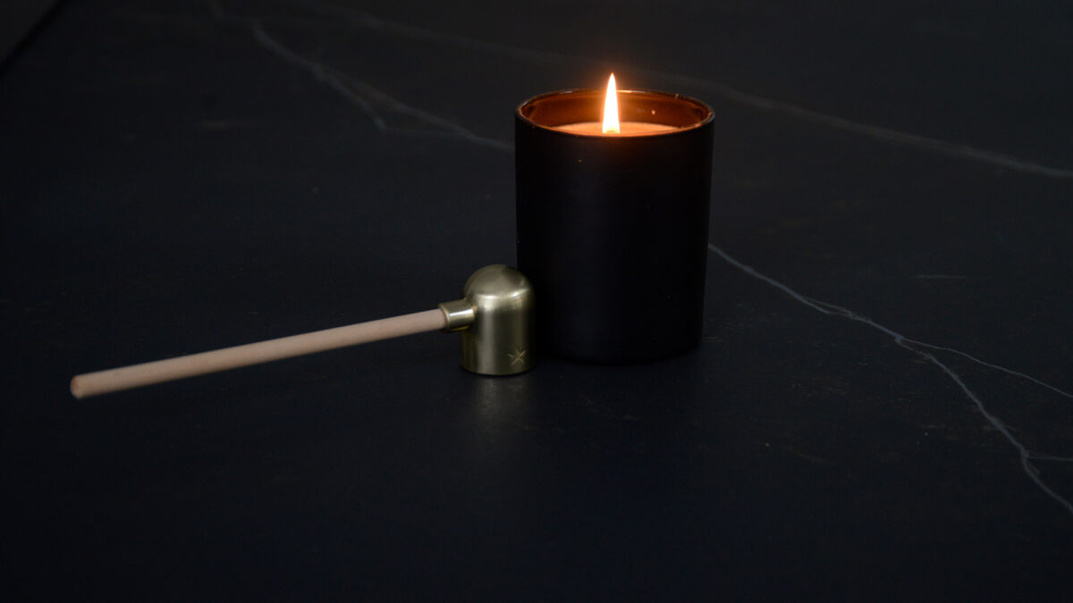 modern candle snuffer shown with candle