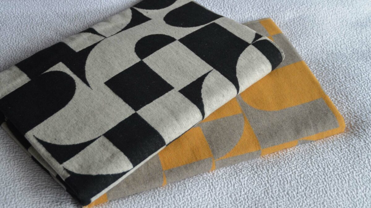 modern graphic print throws stack from above