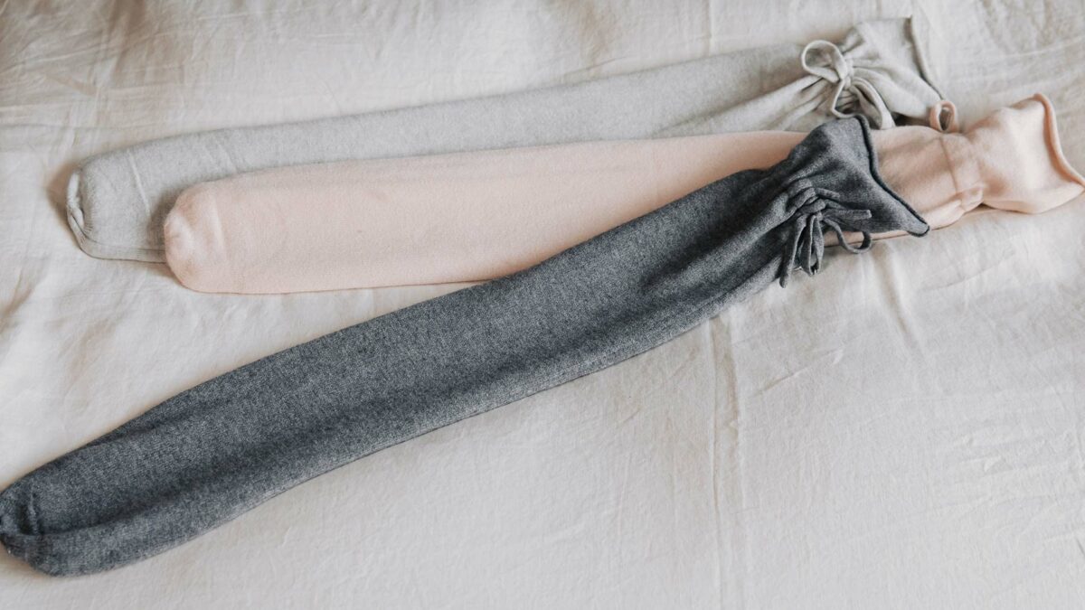 modern long hot water bottles with knitted covers