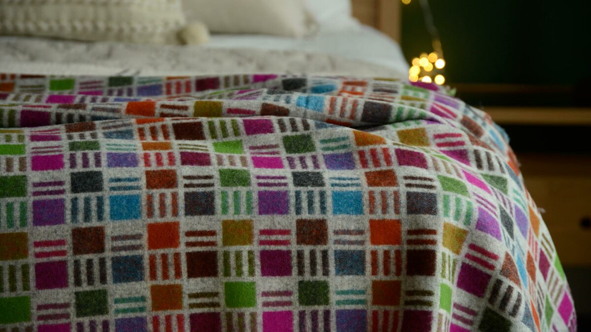 graphic patterned merino lambswool throw multi colours and grey