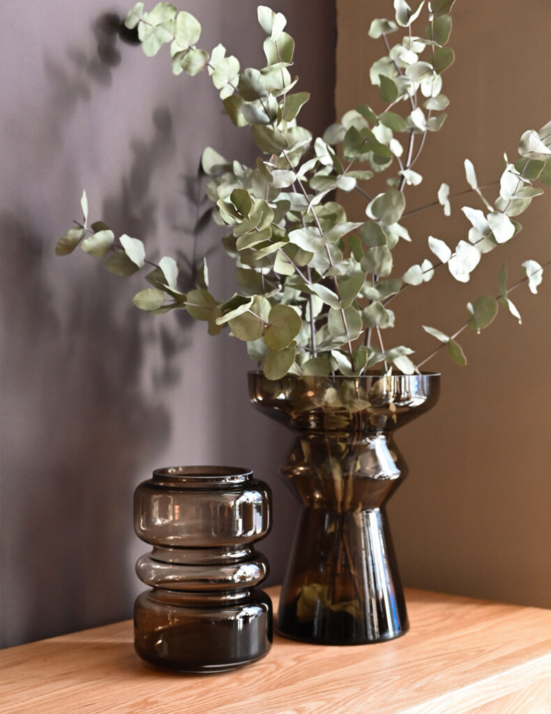 modern smoked glass vases on table top.