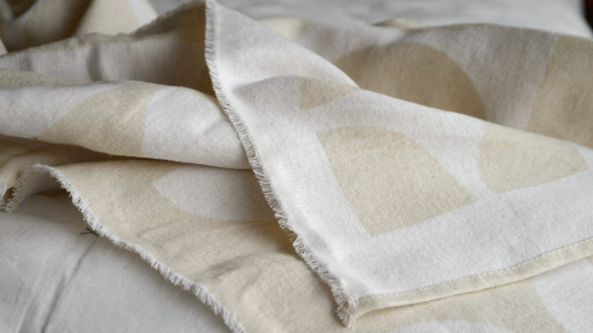 graphic patterned soft cotton throws in ivory and ecru