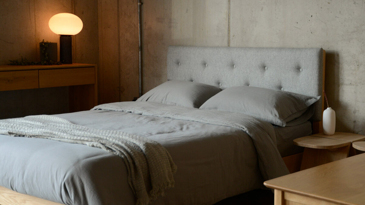 muslin like light and soft cotton bedding in moss grey shown on a kingsize bed