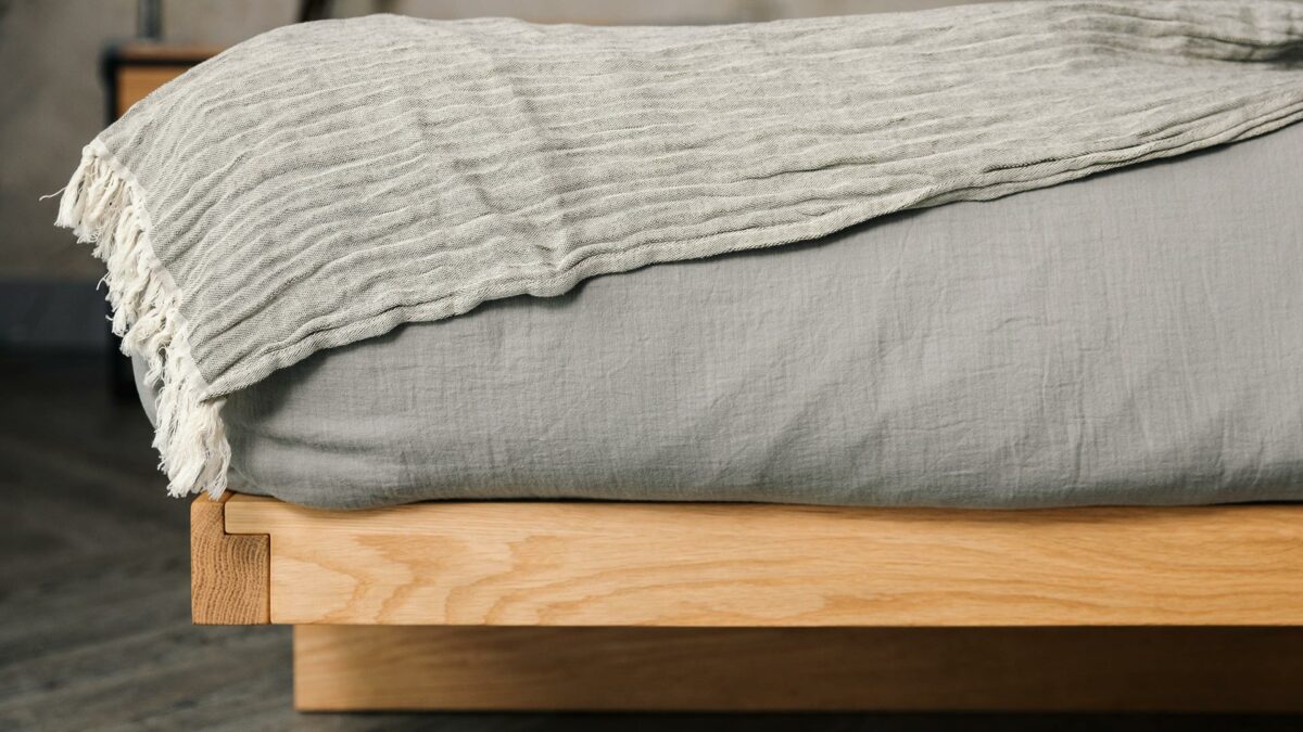 moss grey throw with muslin bedding