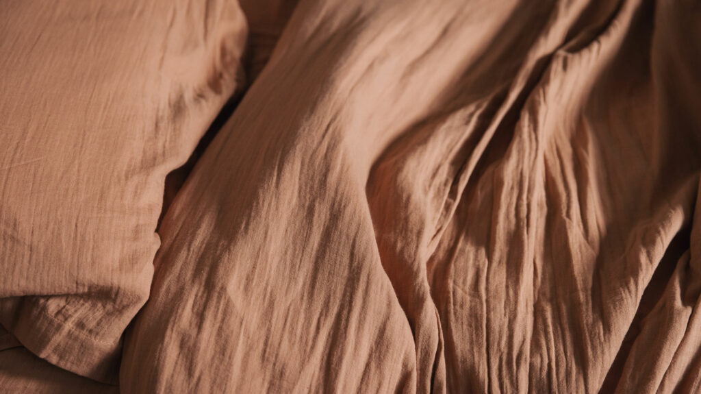 muslin look soft cotton bedding in clay pink shown close up