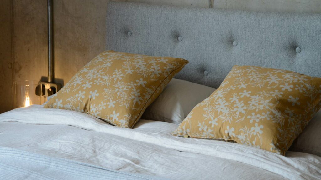 floral print cushions in a deep mustard yellow and taupe colour