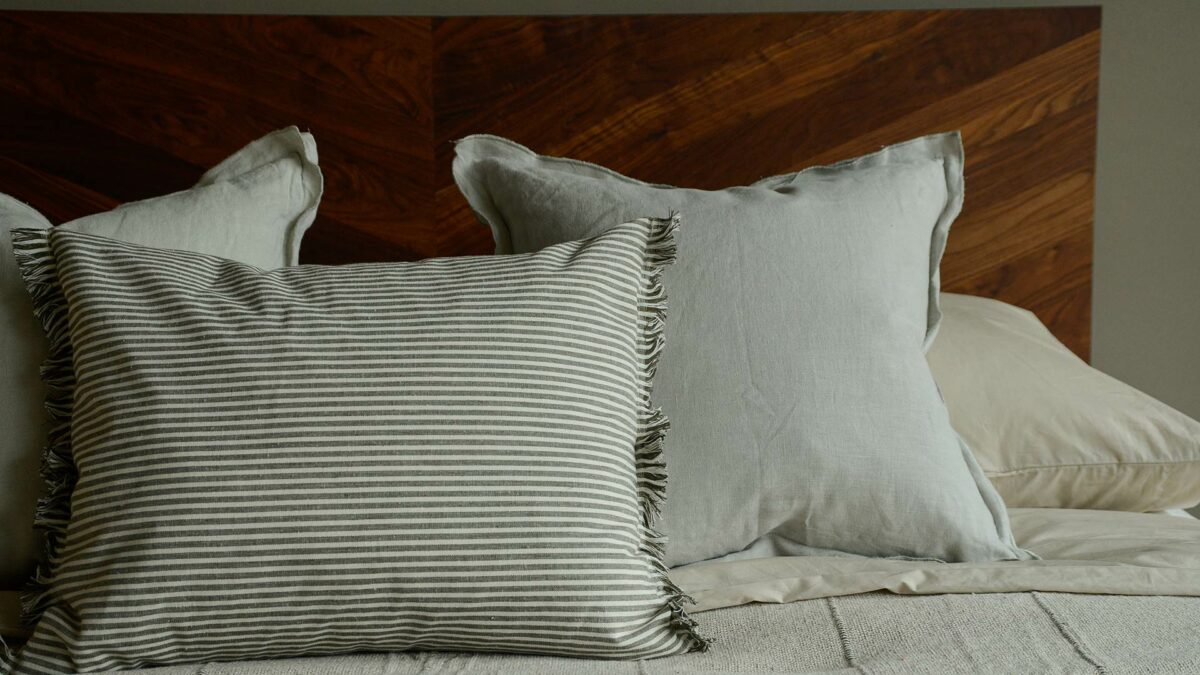 olive green and white striped cotton cushions with tassel edging