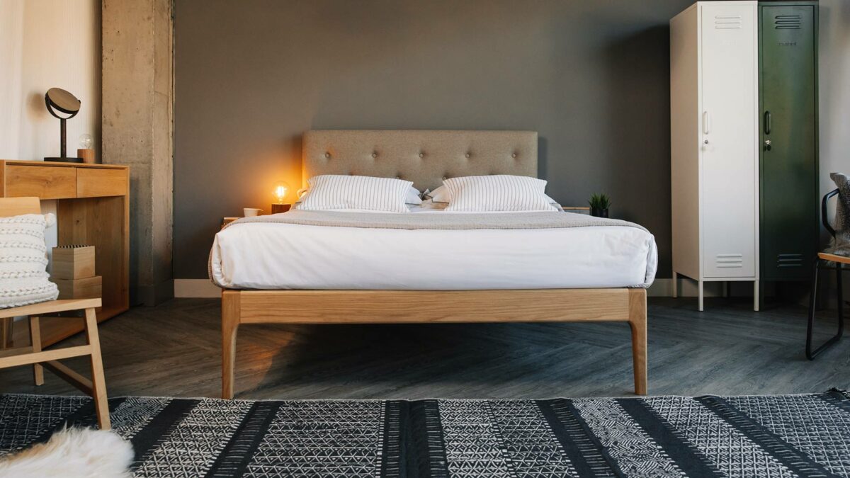 Hand crafted solid wooden bed with upholstered headboard