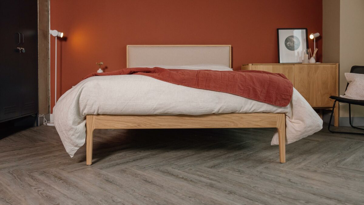 oak Carlisle bed with upholstered headboard panel in Amatheon front