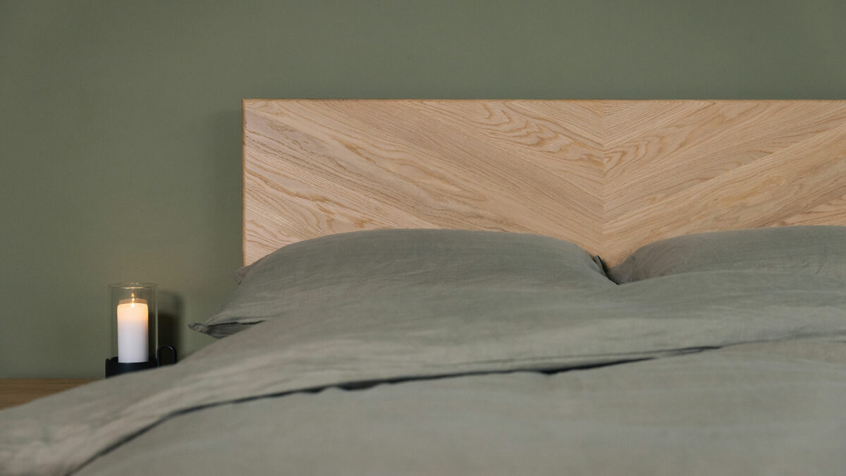 The Highbury bed has a solid wood headboard with chevron pattern here in oak