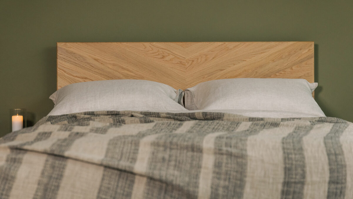 luxurious textured weave bedspread with stripes of taupe and black threads shown on a Highbury oak bed