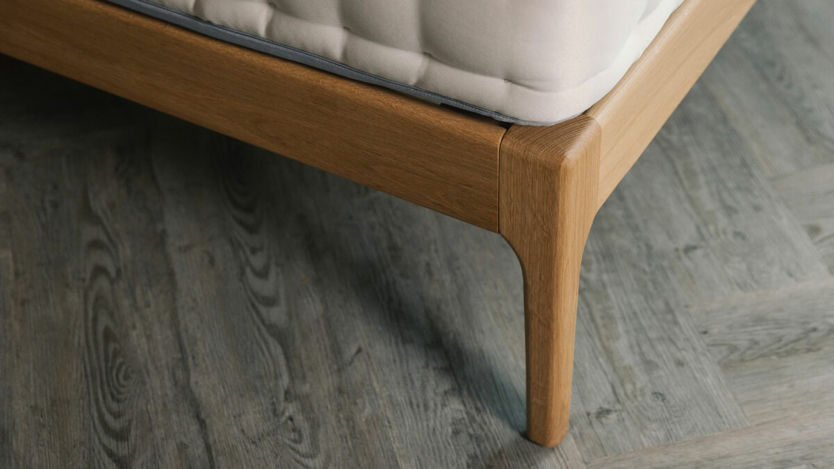 a close up view of the foot end leg of our oak Highbury bed