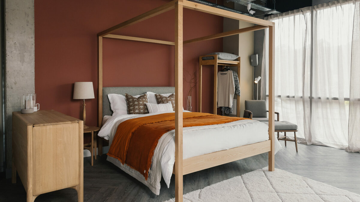 oak Highland 4 poster bed with burnt orange velvet quilt