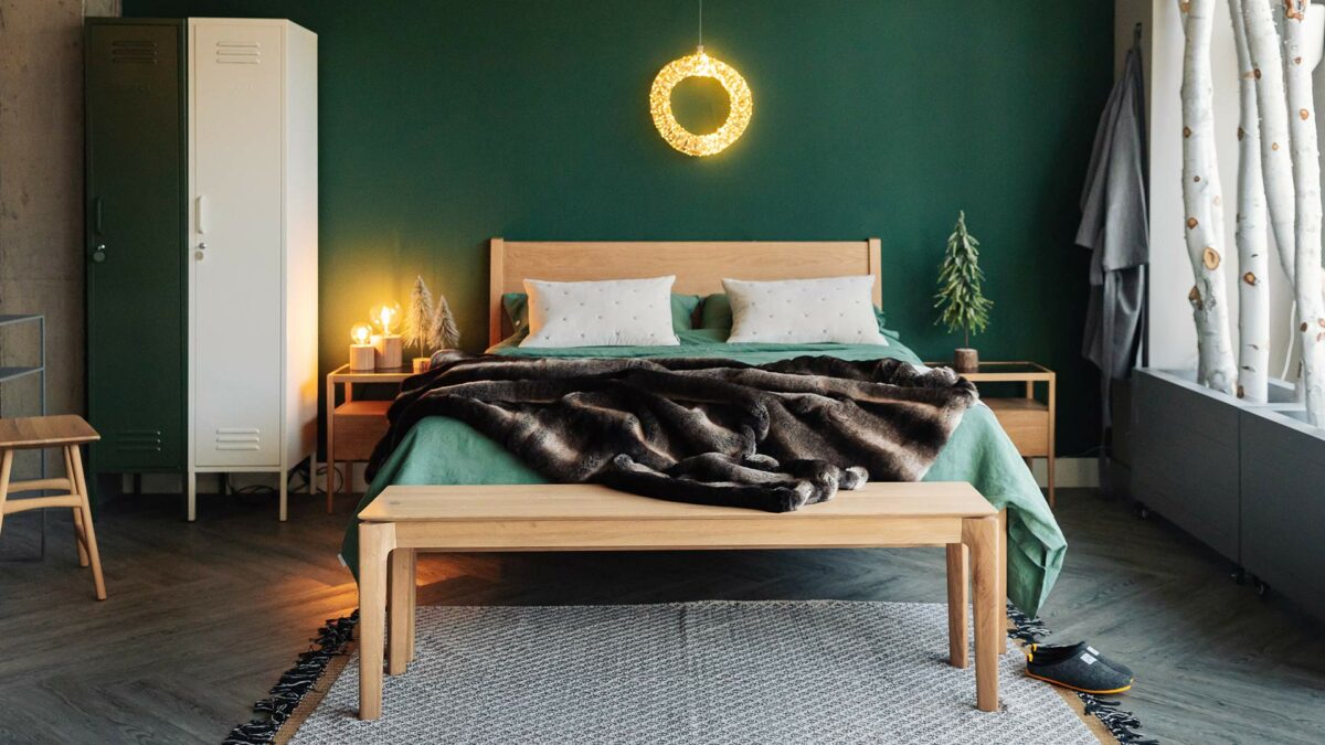 oak bed and bench with fuax fur bedspread and halo wreath