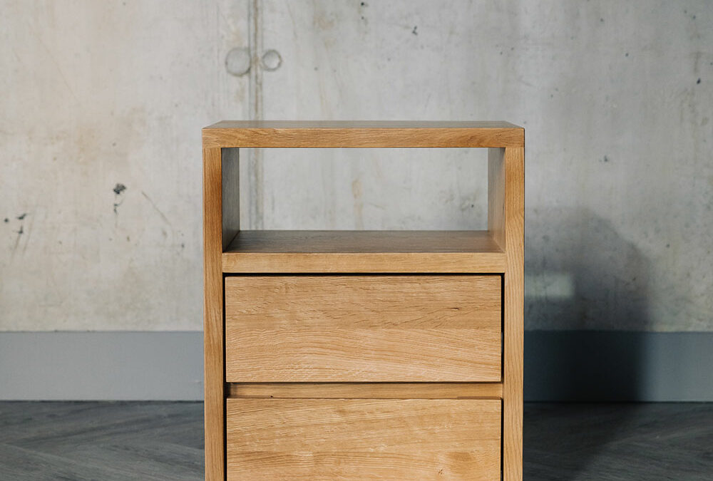 A solid oak bedside table with 2 drawers and an open shelf