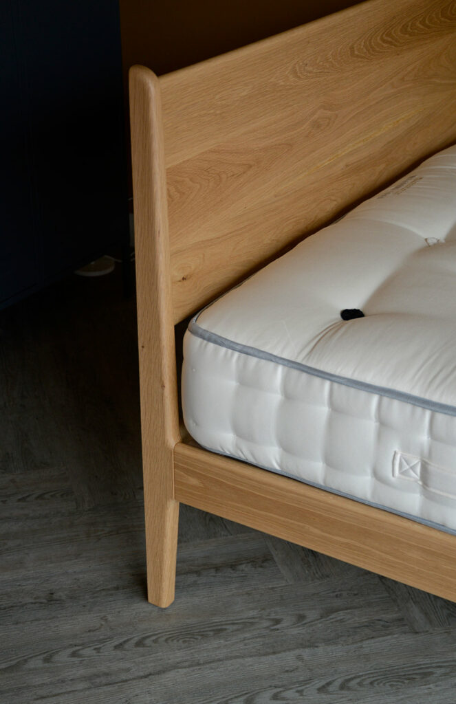Our mid century style Camden bed made from solid oak wood a close up of the headboard leg join