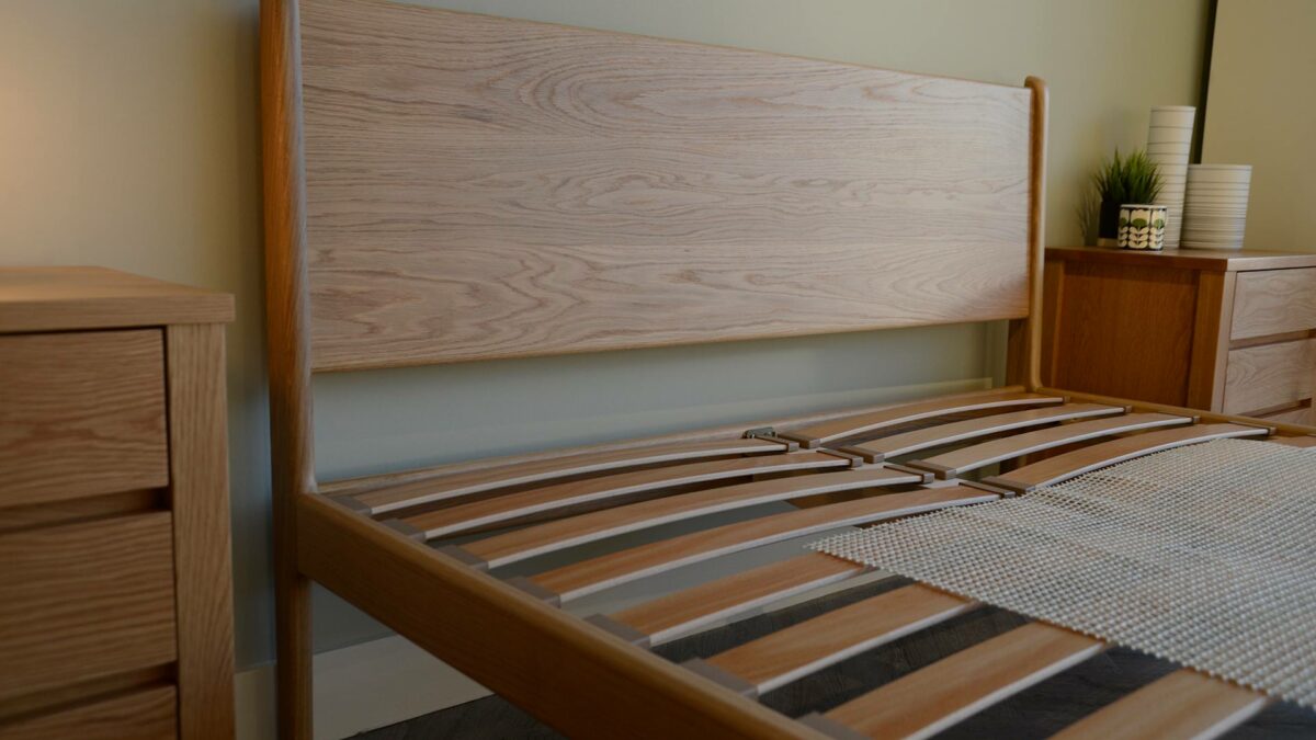 A view of the handmade oak Camden bed headboard shown without mattress