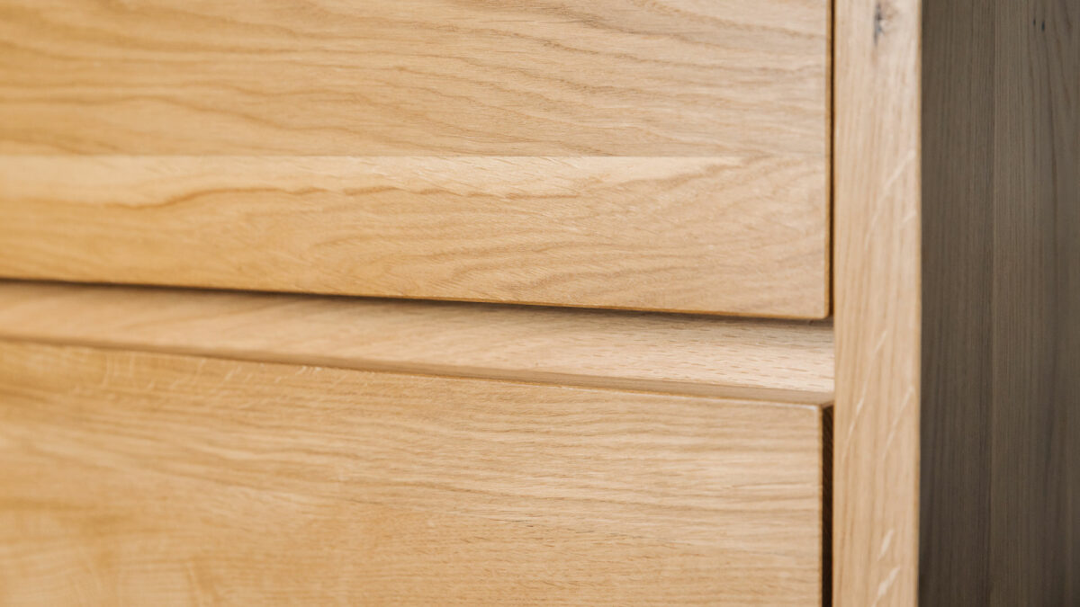 A close up view of a Black Lotus solid oak bedroom storage chest