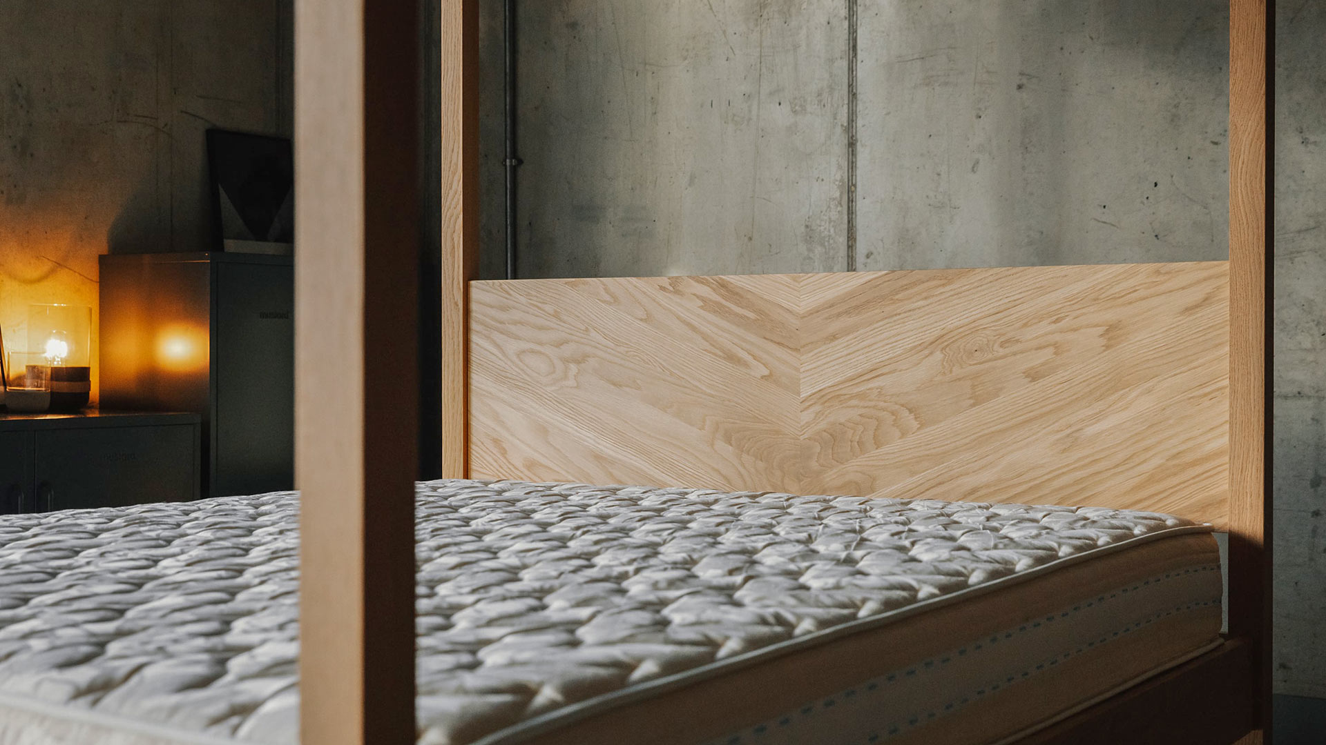 A closer view of the chevron pattern headboard of the Kingsize Kelham 4 Poster bed in solid oak