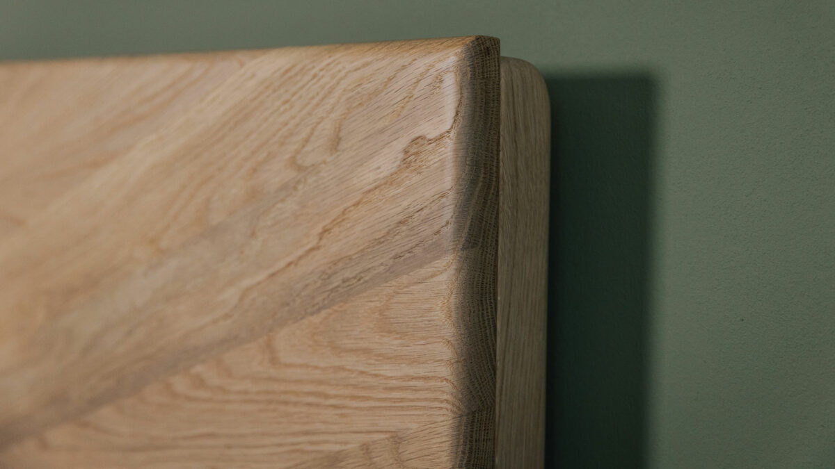 detail view of the headboard corner and chevron design of an Oak Highbury bed