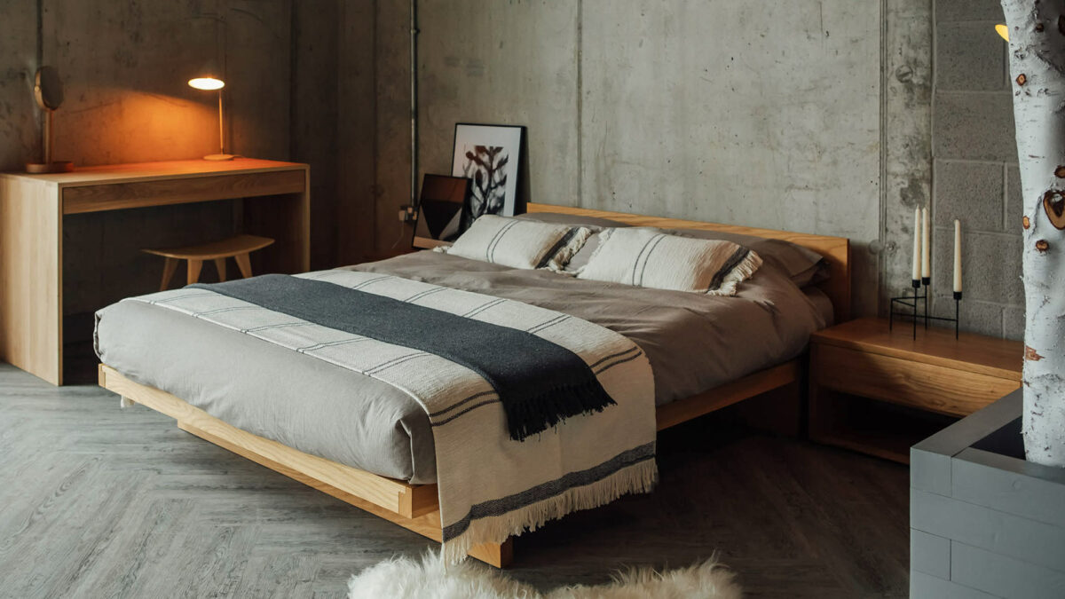 Scandi style bedroom featuring our solid oak Kyoto bed dressed in organic bedding and cotton throws