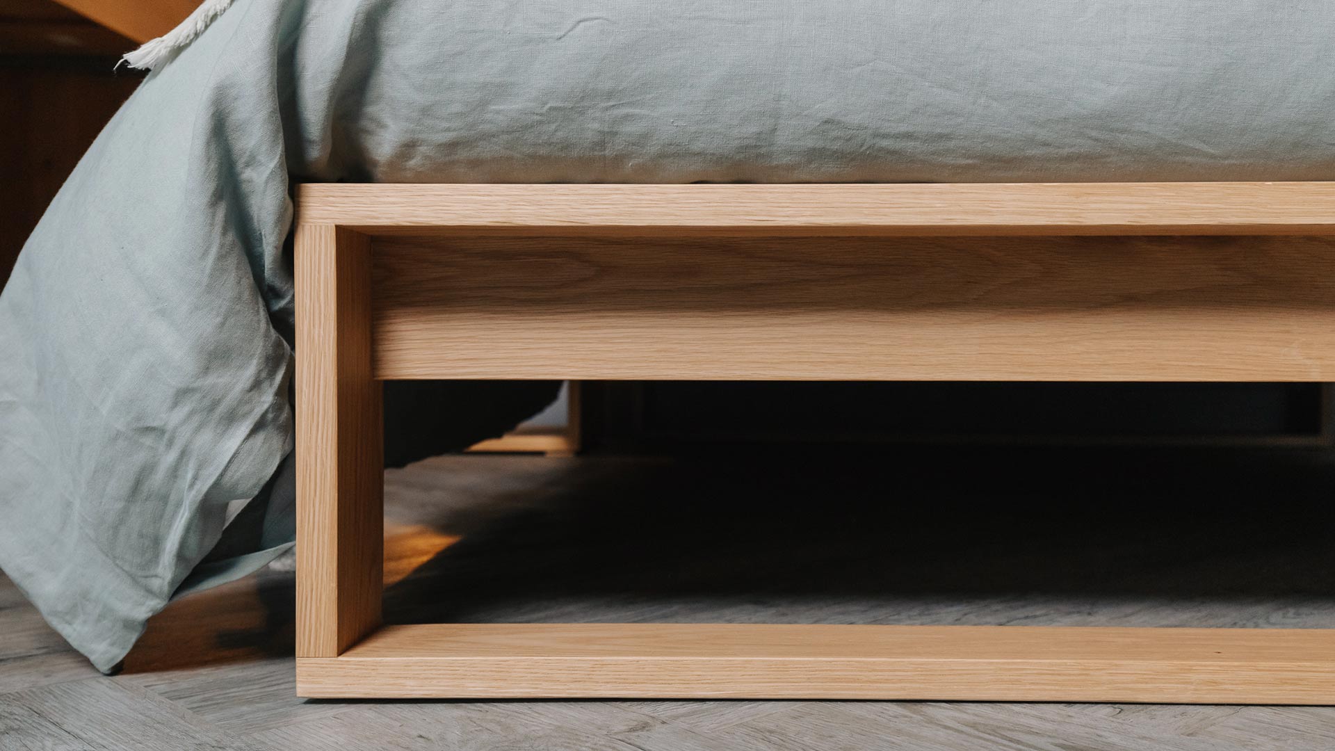 a close up view of the foot end of our contemporary solid wood Leith bed in Oak