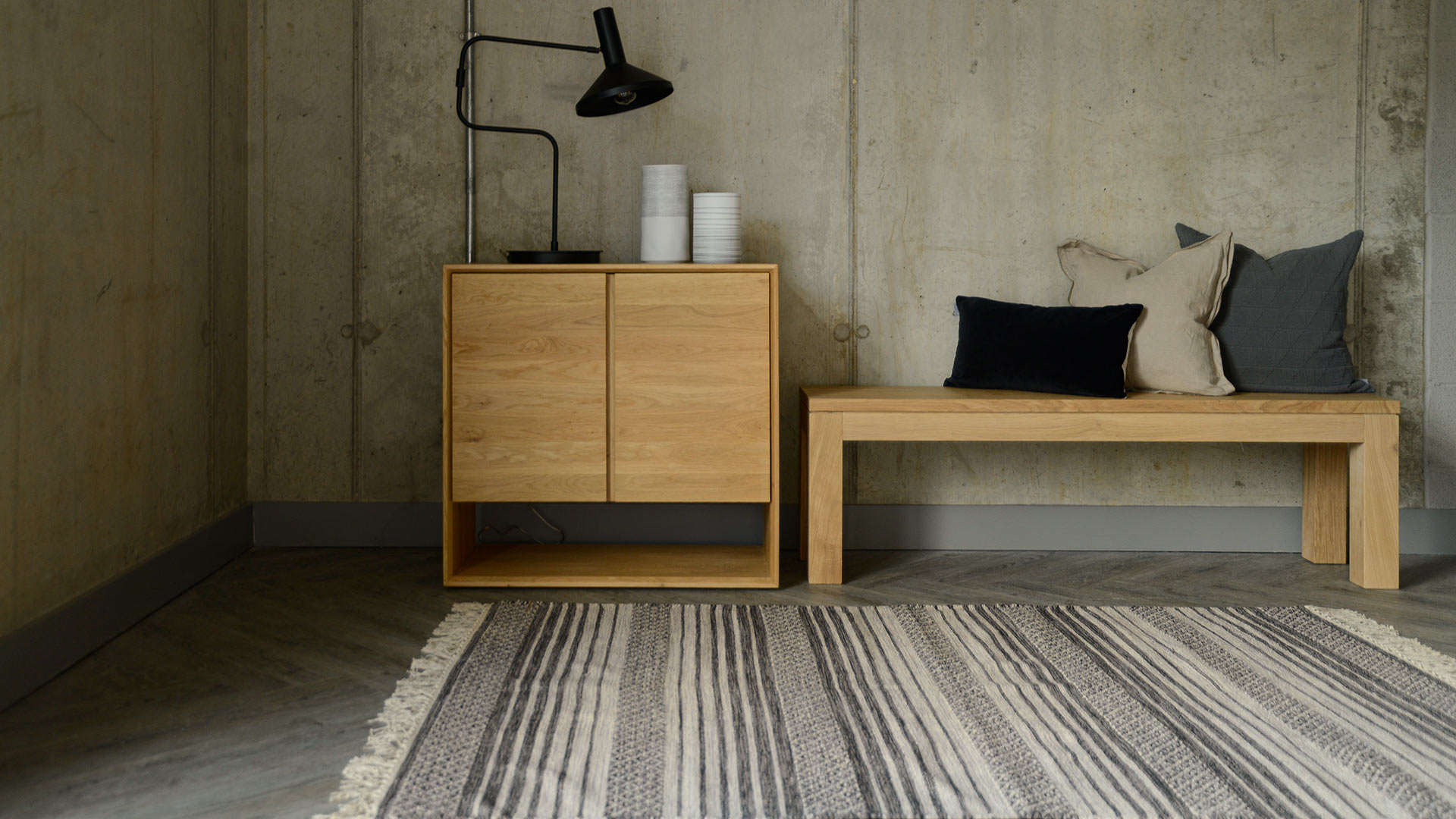 oak nordic cupboard and straight modern bench with neutral furnishings