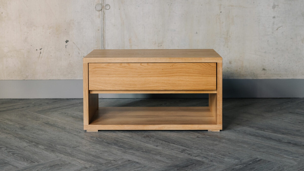 low bedside table with drawer and open shelf and made from solid oak