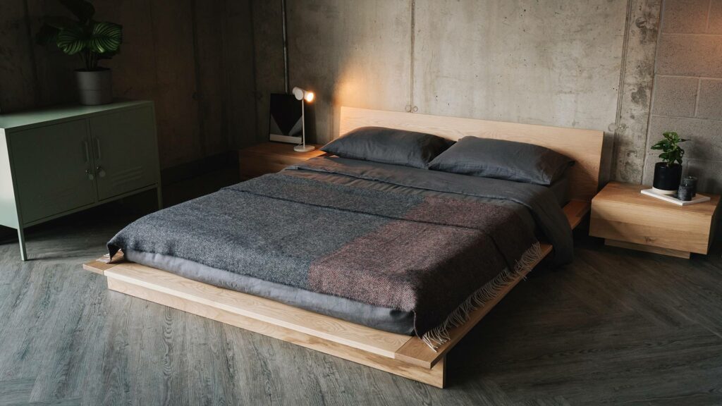 oak oregon bed with Madra bedside tables and grey and orange throw