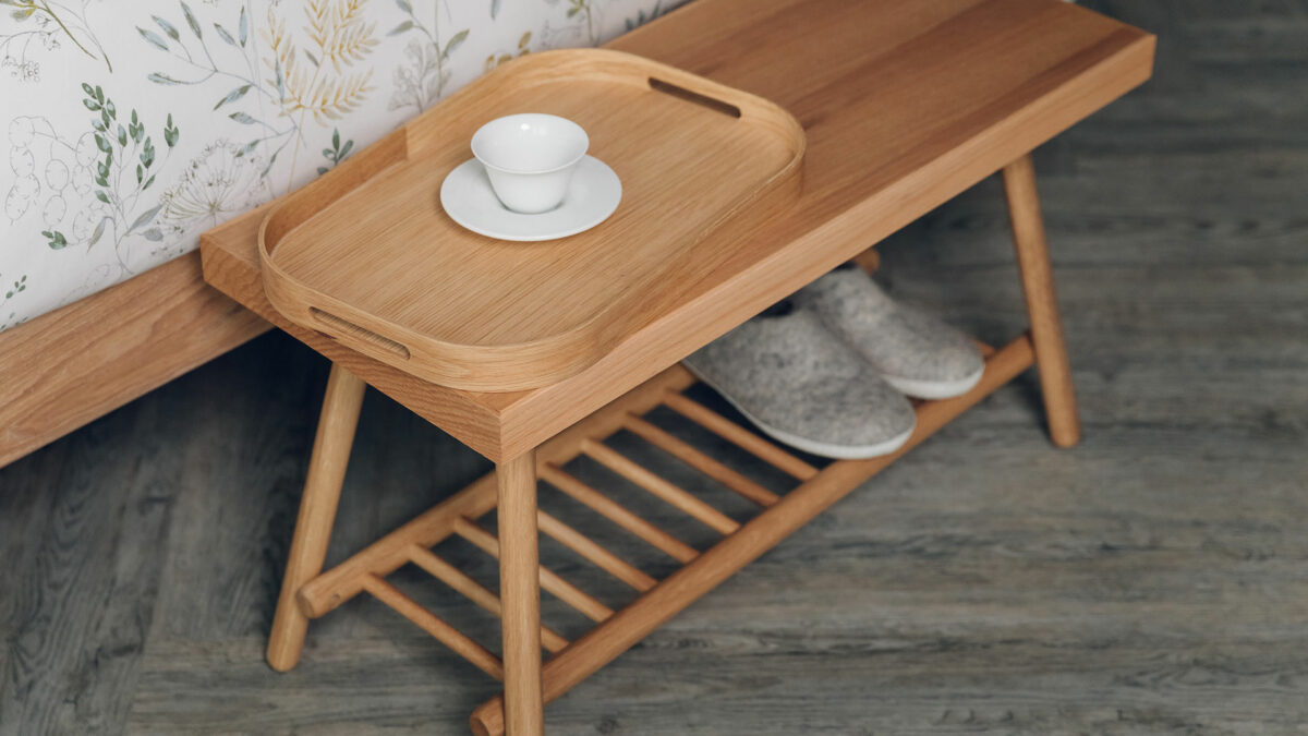 small oak table or bench with a lower spindle shelf
