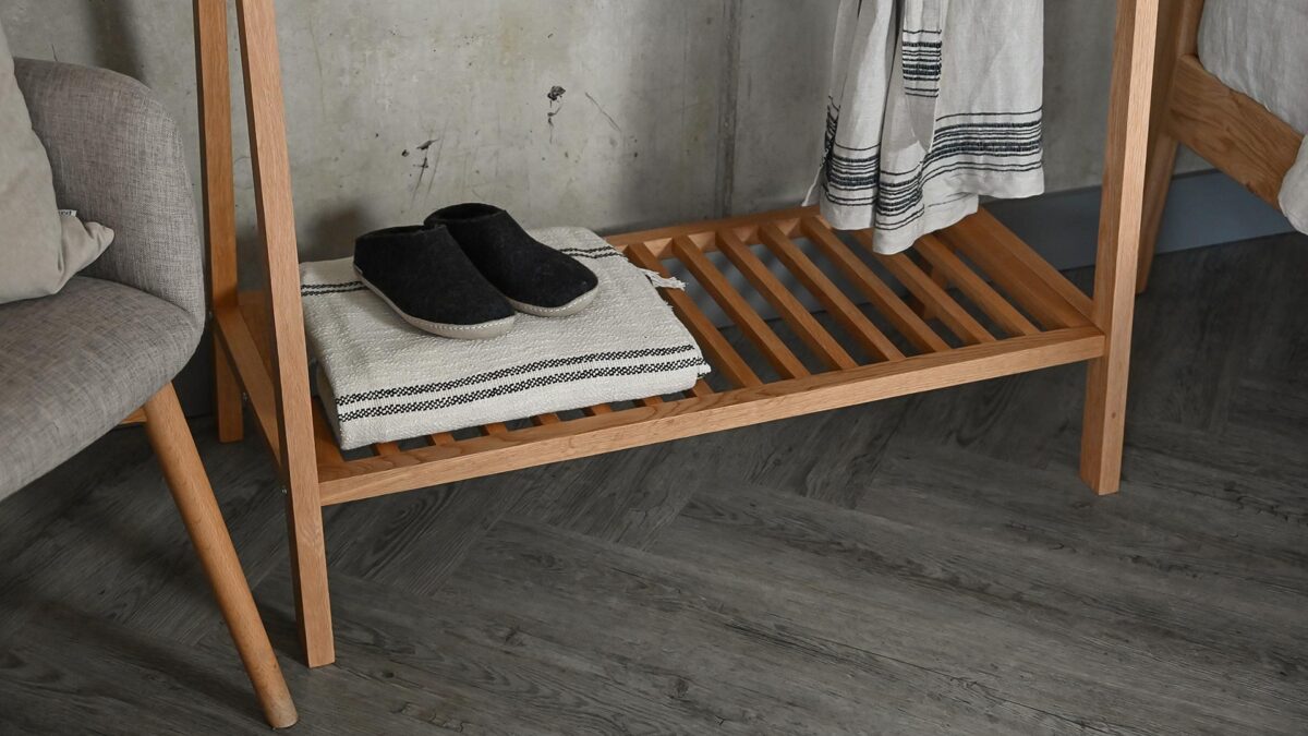 Image focussing on the lower shelf area of the Solid Oak Clothes Rail.